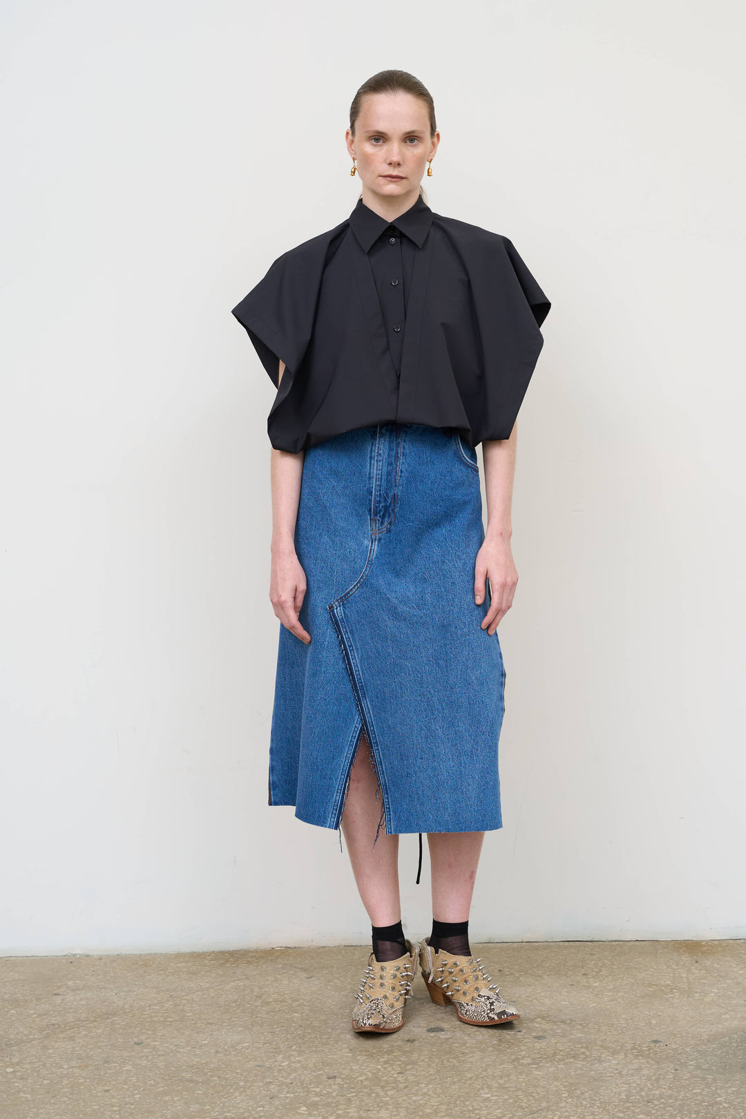 Model is wearing Litkovska black deconstructed wool blend shirt featuring layered tailoring and architectural womenswear design at House of Nomad Stories