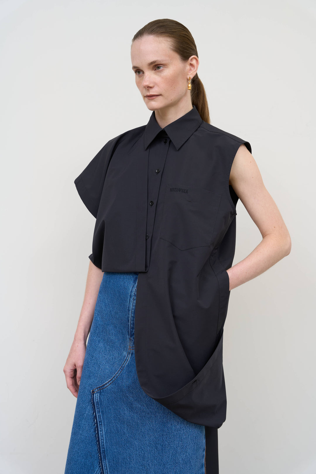Model is wearing Litkovska black deconstructed wool blend shirt featuring layered tailoring and architectural womenswear design at House of Nomad Stories