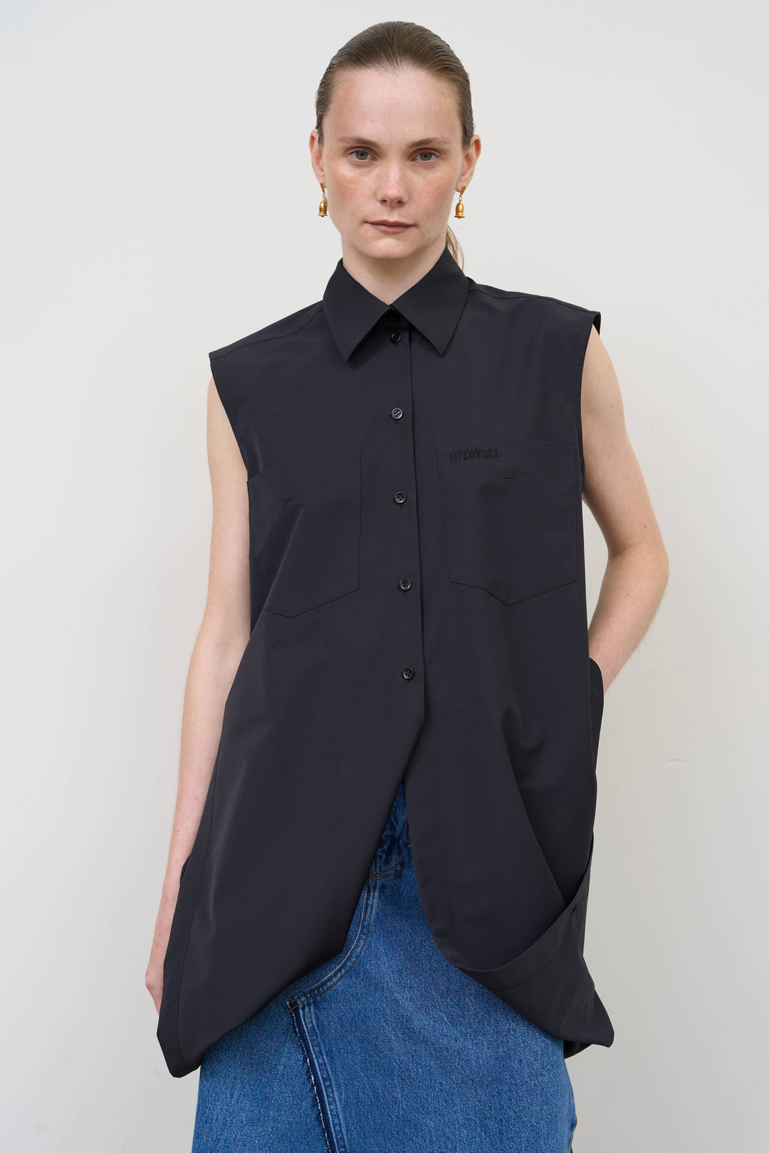 Model is wearing Litkovska black deconstructed wool blend shirt featuring layered tailoring and architectural womenswear design at House of Nomad Stories