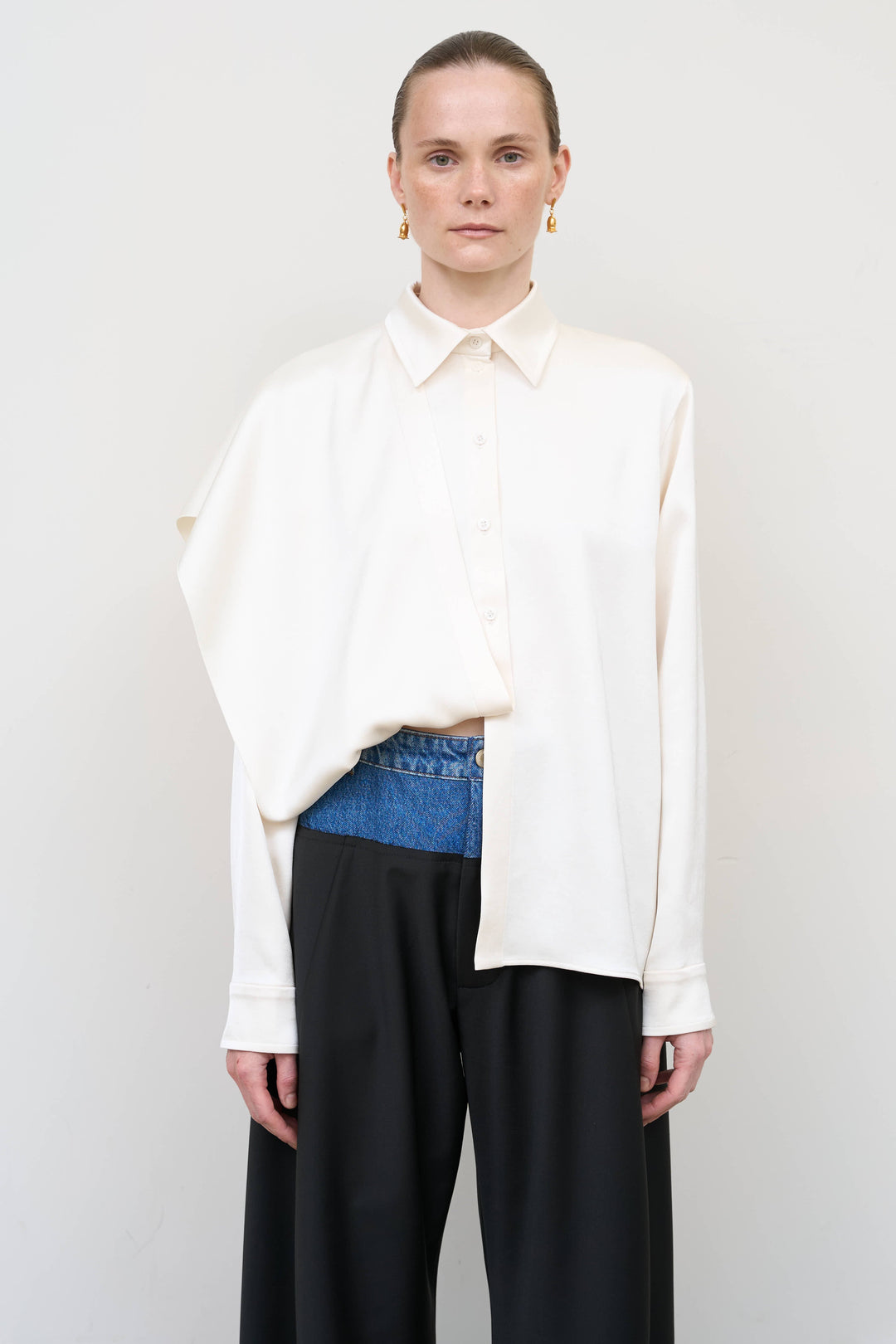 Model is wearing Litkovska ivory blouse with integrated scarf detail, showcasing layered tailoring and fluid contemporary womenswear design from House of Nomad Stories
