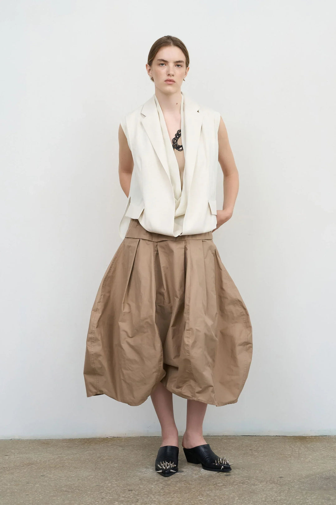 Model is wearing Litkovska sleeveless layered vest with sculptural construction selected by House of Nomad Stories