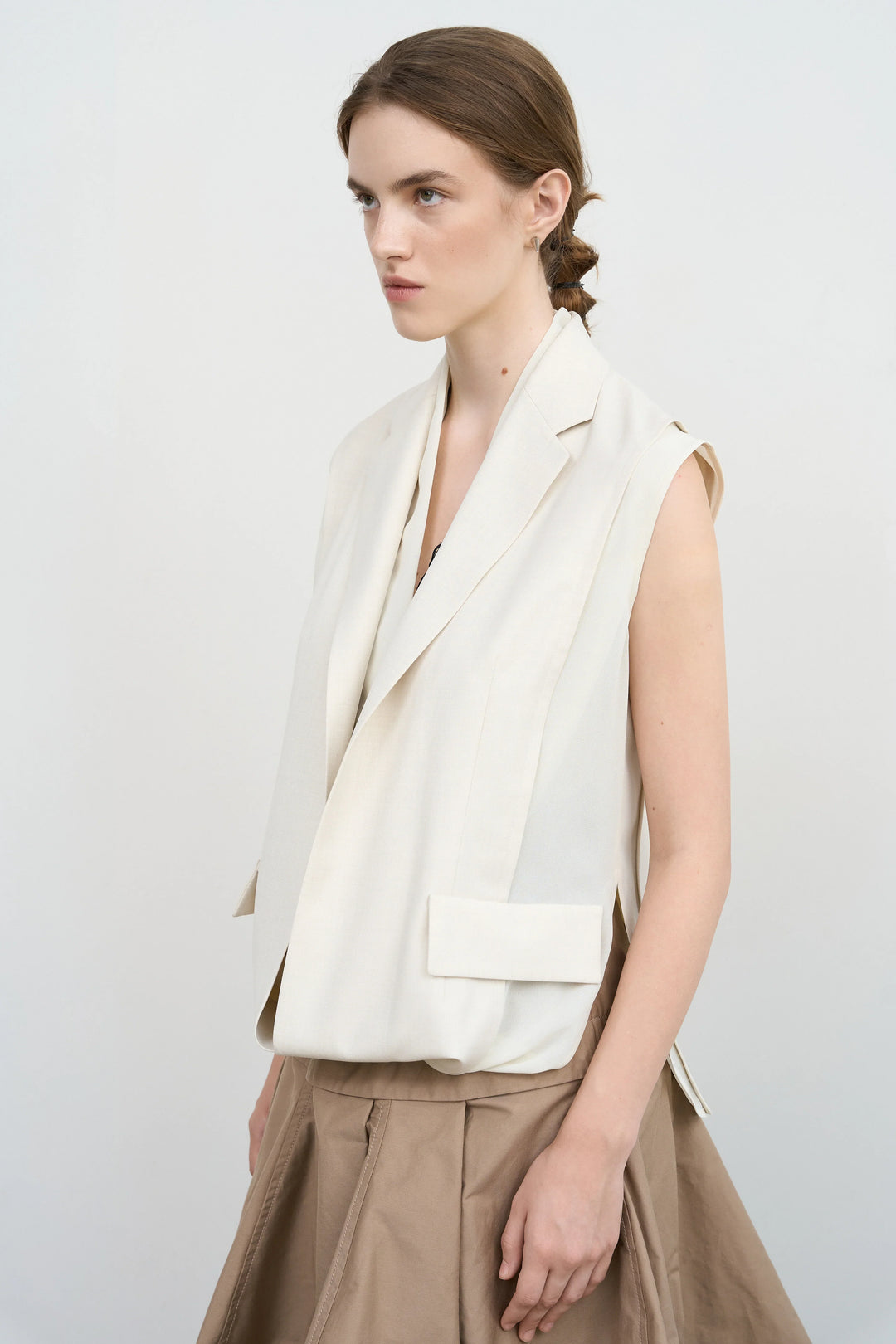 Model is wearing Litkovska sleeveless layered vest with sculptural construction selected by House of Nomad Stories