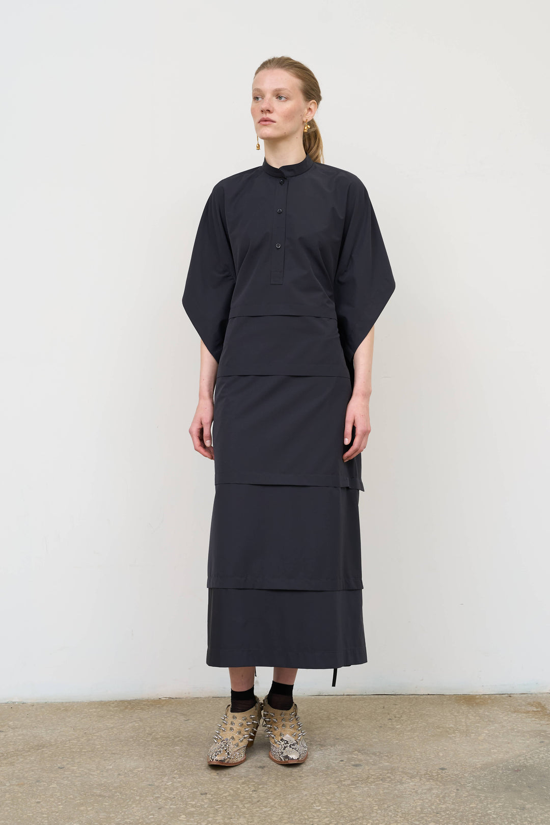 Model is wearing Litkovska midi dress with capelet detail, showcasing layered tailoring and contemporary Ukrainian womenswear at House of Nomad Stories