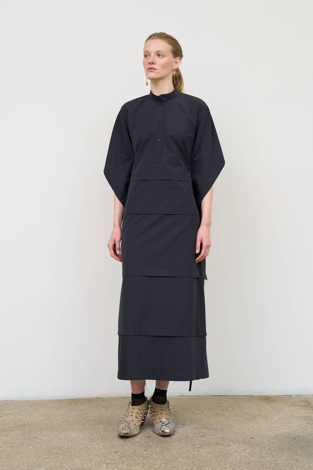 Model is wearing Litkovska midi dress with capelet detail, showcasing layered tailoring and contemporary Ukrainian womenswear at House of Nomad Stories