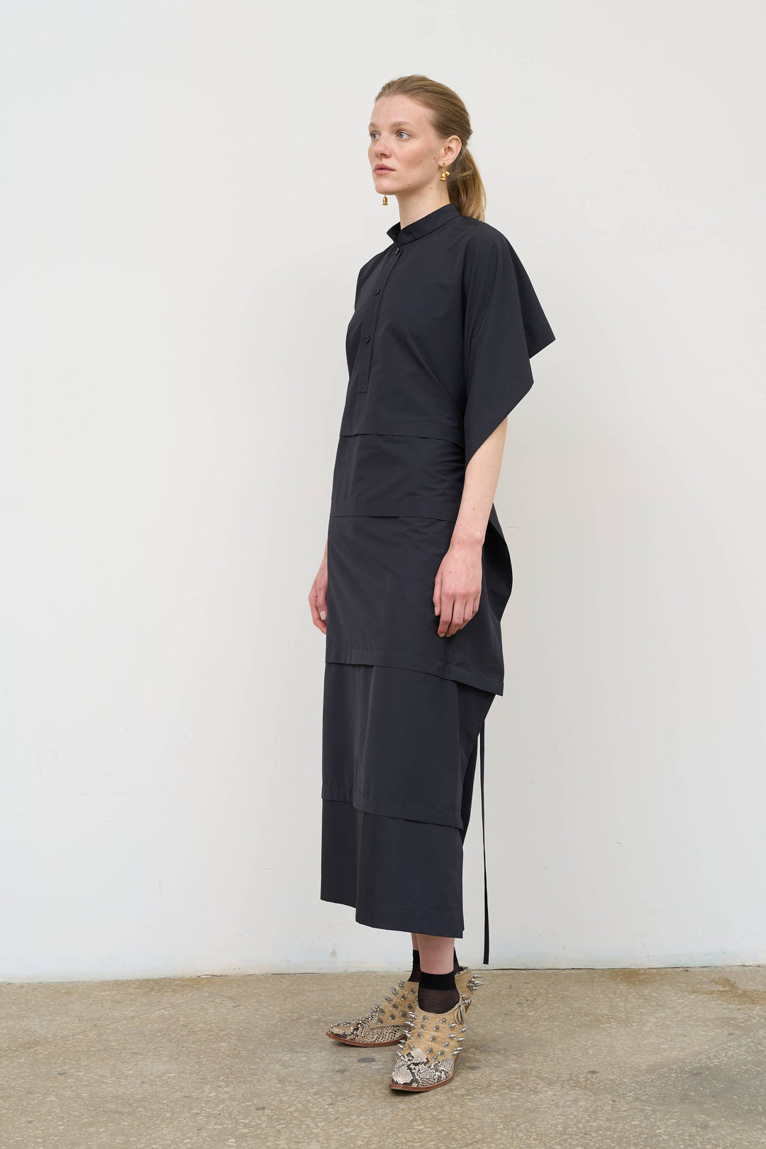 Model is wearing Litkovska midi dress with capelet detail, showcasing layered tailoring and contemporary Ukrainian womenswear at House of Nomad Stories