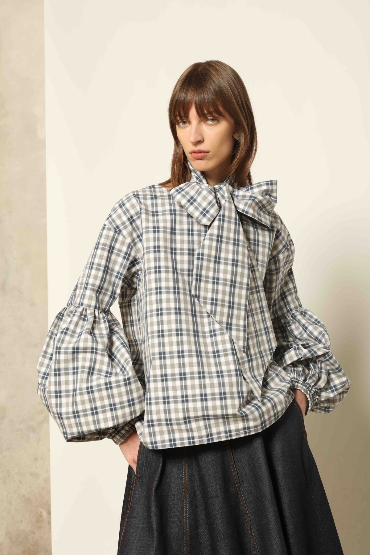 Model wearing Lulu Maxi Check Popeline Cotton Blouse with Scarf by House of Woven Stories, featuring balloon sleeves, grey-white-indigo check, and versatile scarf detail.