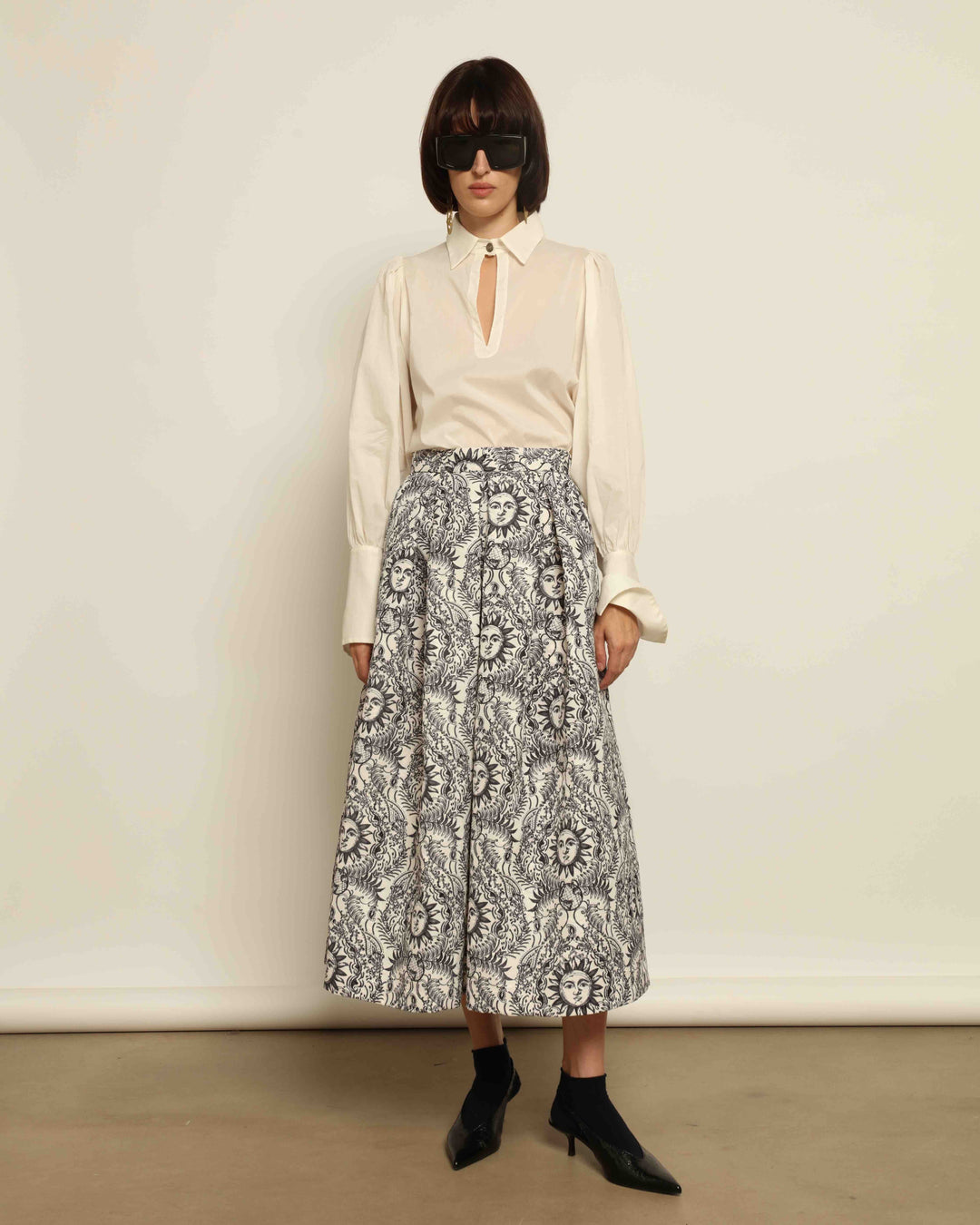 Model is wearing Sun Black and White Skirt by Lunatica Milano. Romantic floral skirt in classic black and white. Elegant, feminine, and handcrafted in Italy. Part of House of Nomad Stories selection.