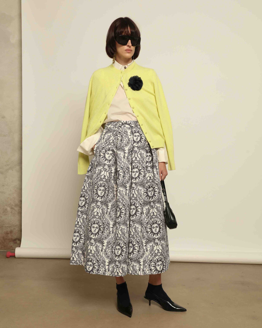 Model is wearing Sun Black and White Skirt by Lunatica Milano. Romantic floral skirt in classic black and white. Elegant, feminine, and handcrafted in Italy. Part of House of Woven Stories selection.