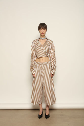 Carla Rust Striped Cotton Bermuda by Maison Jejia, crafted in soft cotton with warm rust and white stripes, a structured waistband, oversized patch pockets and a relaxed knee-length silhouette.