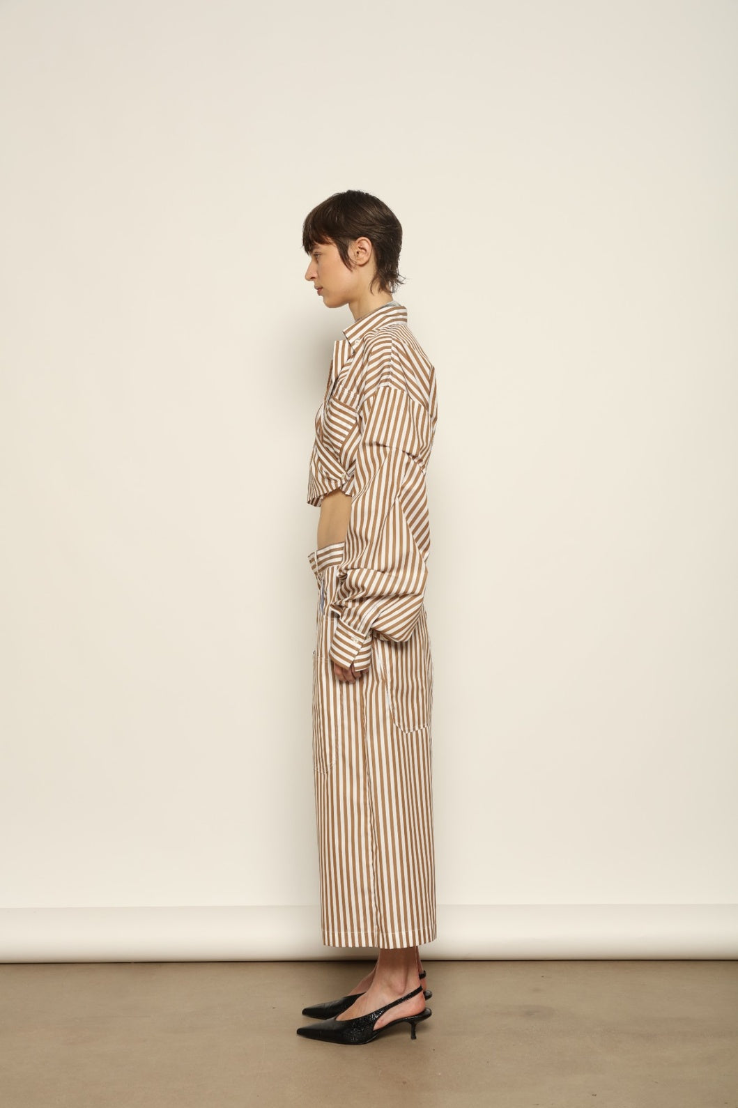 Carla Rust Striped Cotton Bermuda by Maison Jejia, crafted in soft cotton with warm rust and white stripes, a structured waistband, oversized patch pockets and a relaxed knee-length silhouette.
