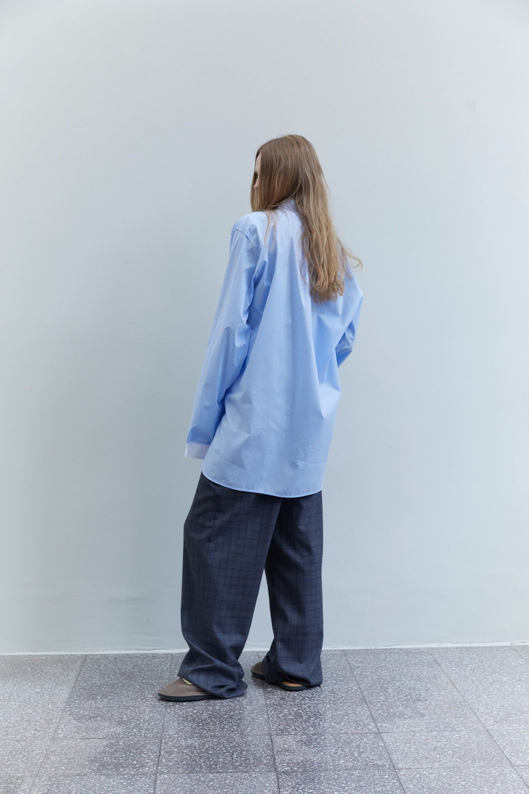 Back view of the Crazy Smoking Sky Blue Plissé Shirt by Maison Jejia, featuring a relaxed drape and softly textured cotton construction.