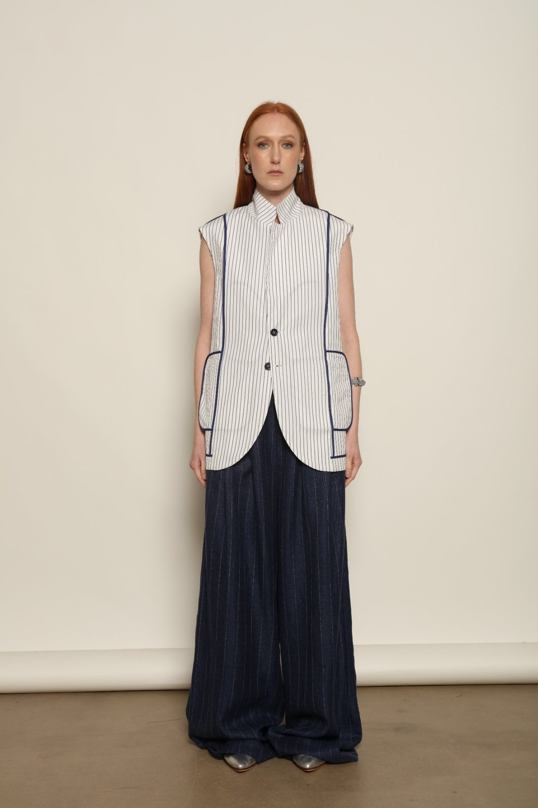 Harry Gilet by Maison Jejia in crisp white cotton with fine blue stripes and a clean sleeveless tailored silhouette.