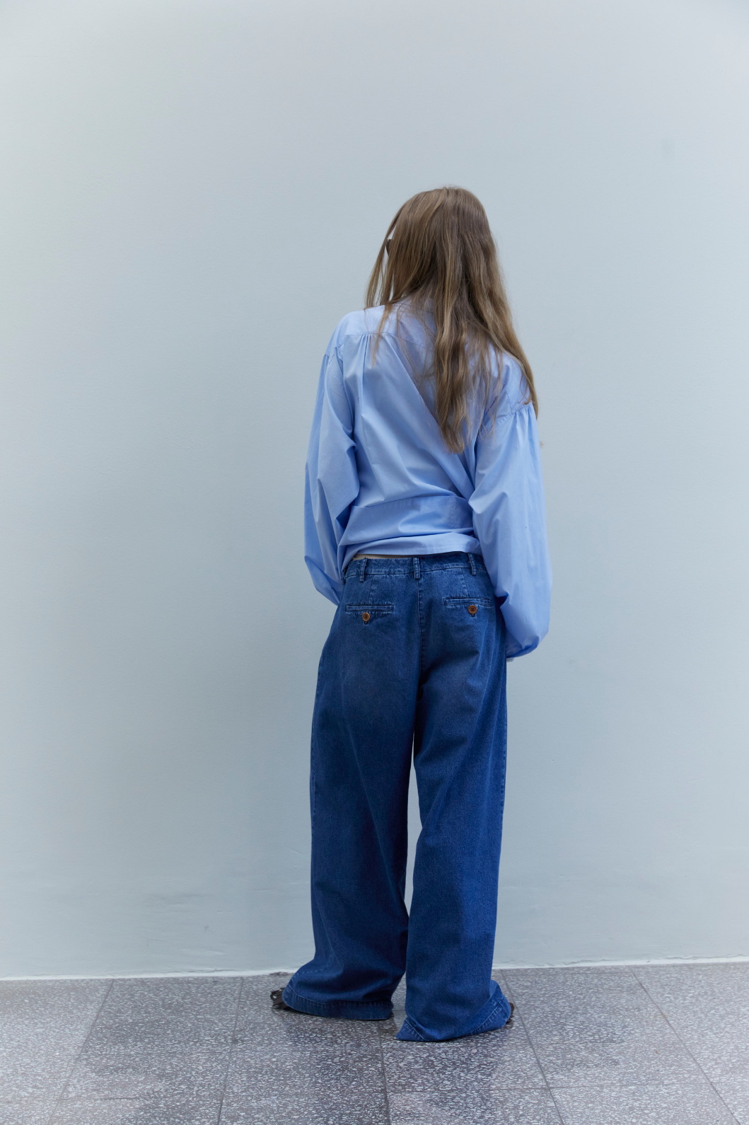 Back view of the Katherine Washed Blue Denim Cotton Pant by Maison Jejia, featuring a generous wide-leg cut and soft washed denim finish.