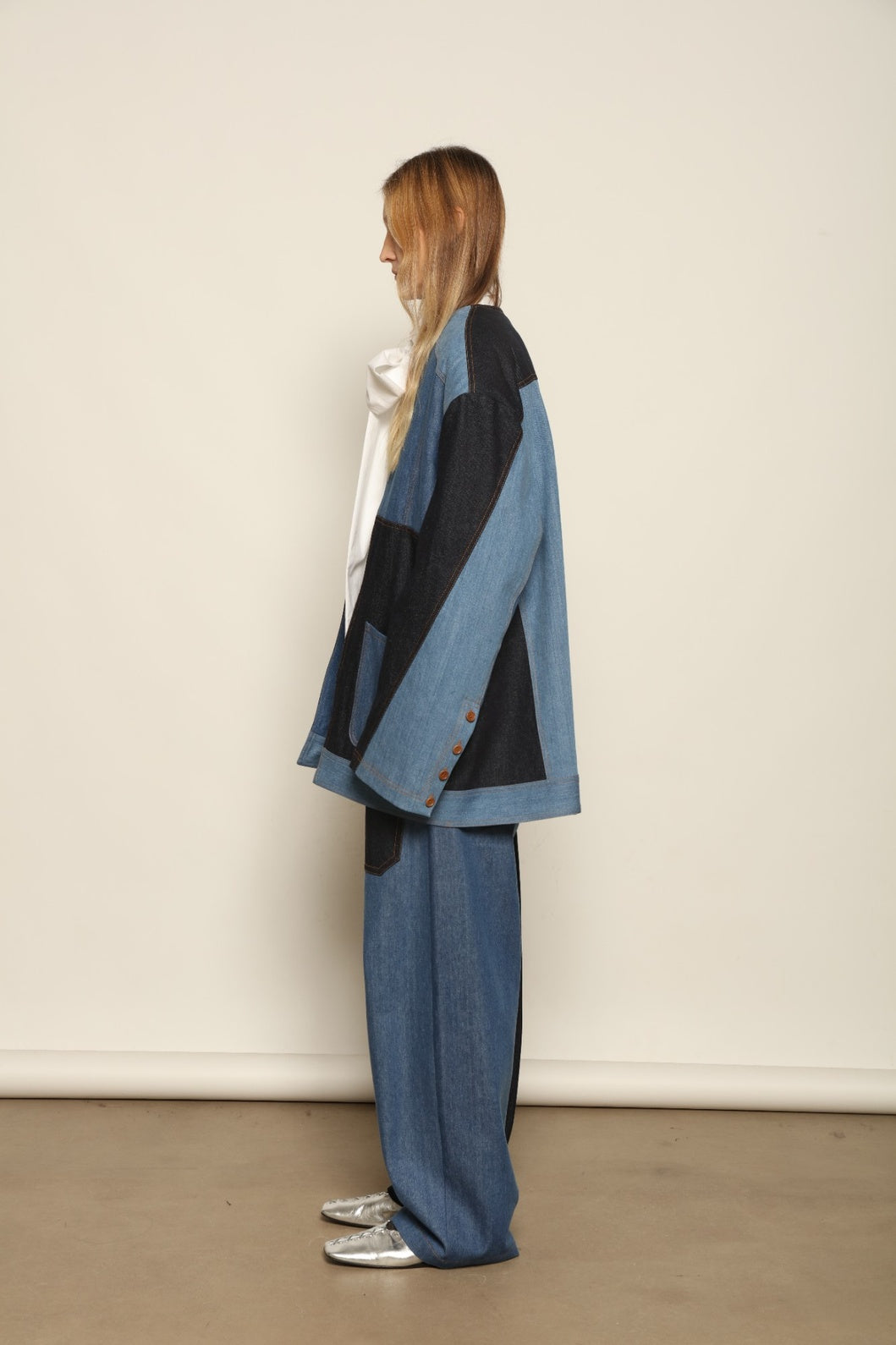 Model is wearing the Jonathan Denim Patchwork Blazer by Maison Jejia, an artisanal tailored blazer made from mixed-wash denim panels with sculpted shoulders and a relaxed sharp silhouette, curated in the House of Nomad Stories selection