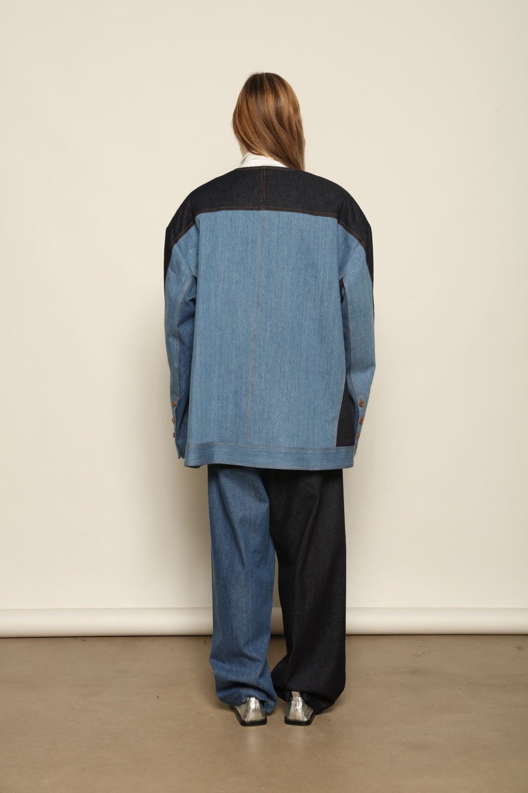 Model is wearing the Jonathan Denim Patchwork Blazer by Maison Jejia, an artisanal tailored blazer made from mixed-wash denim panels with sculpted shoulders and a relaxed sharp silhouette, curated in the House of Nomad Stories selection