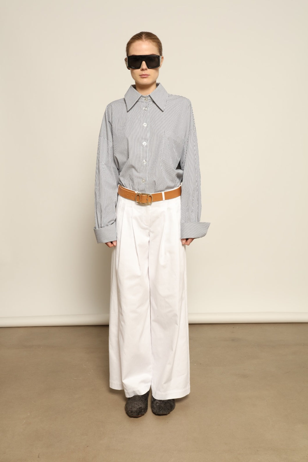 Model is wearing the Katherine White A-Line Pant by Maison Jejia, structured cotton trousers with an elongating A-line silhouette, curated in the House of Nomad Stories selection.