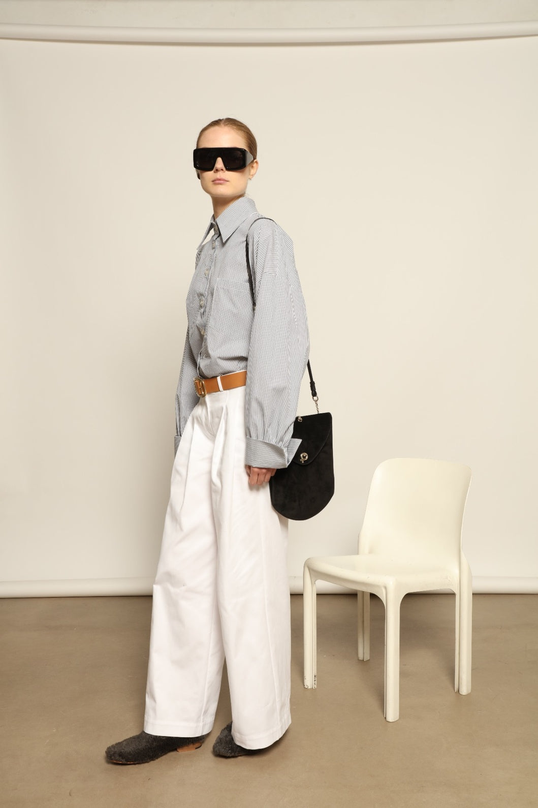 Model is wearing the Katherine White A-Line Pant by Maison Jejia, structured cotton trousers with an elongating A-line silhouette, curated in the House of Nomad Stories selection.