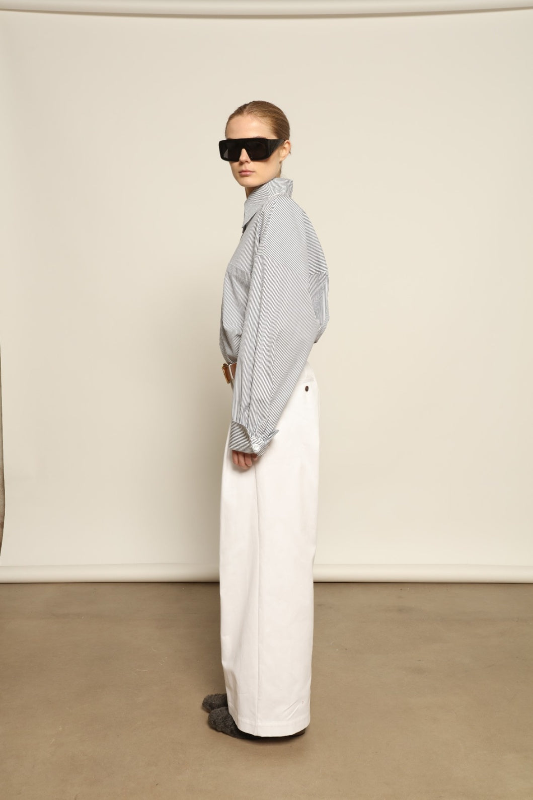 Model is wearing the Katherine White A-Line Pant by Maison Jejia, structured cotton trousers with an elongating A-line silhouette, curated in the House of Nomad Stories selection.
