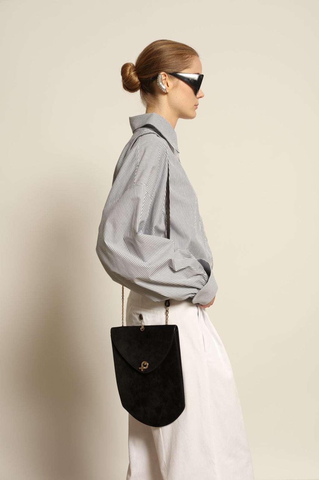 Model is wearing the Katherine White A-Line Pant by Maison Jejia, structured cotton trousers with an elongating A-line silhouette, curated in the House of Nomad Stories selection.