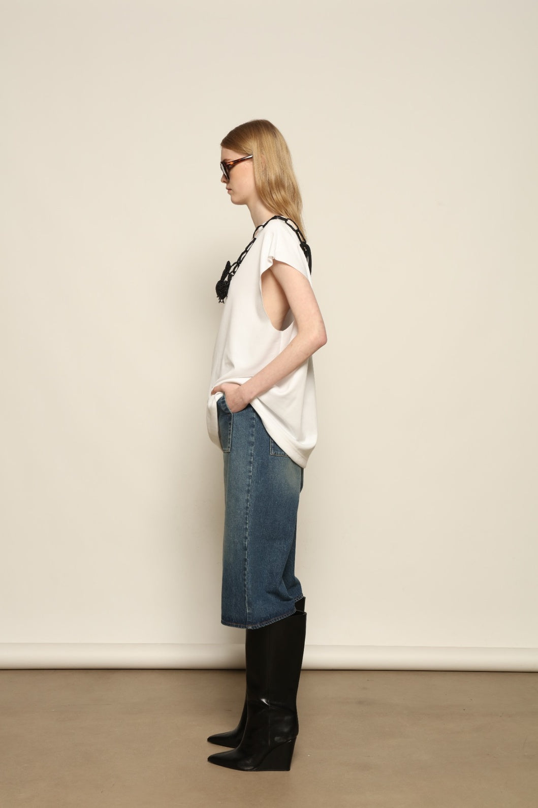 Model is wearing the Tea Cotton Jersey T-Shirt with Black Crab by Maison Jejia, a relaxed cotton tee featuring a playful beaded crab necklace detail, curated in the House of Nomad Stories selection.