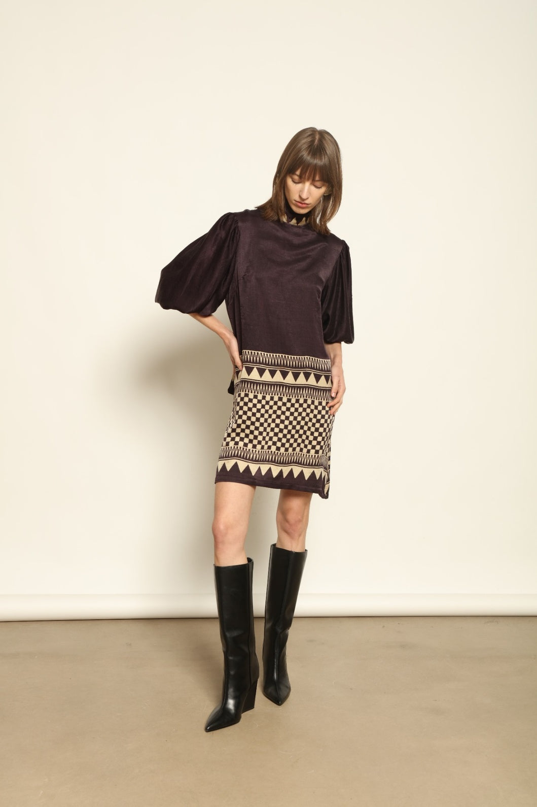 Model is wearing the Malaga Short Silk Dress with Belt by House of Nomad Stories, hand-printed in Ajrakh silk with balloon sleeves and a waist belt.