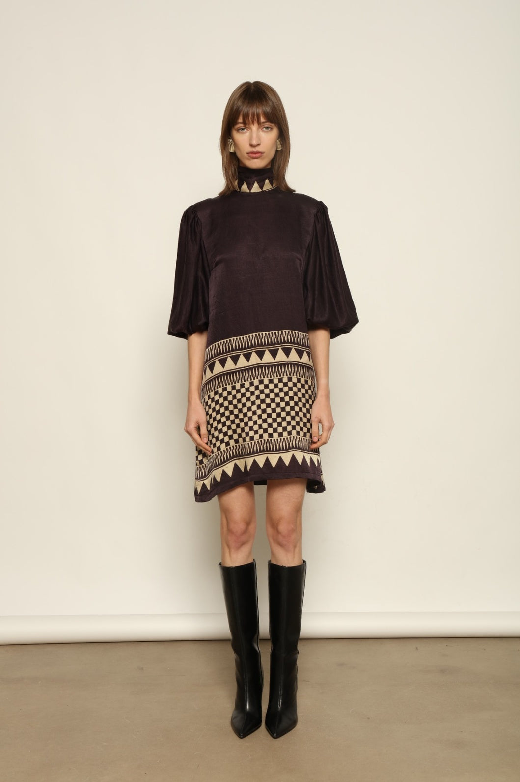 Model is wearing the Malaga Short Silk Dress with Belt by House of Nomad Stories, hand-printed in Ajrakh silk with balloon sleeves and a waist belt.