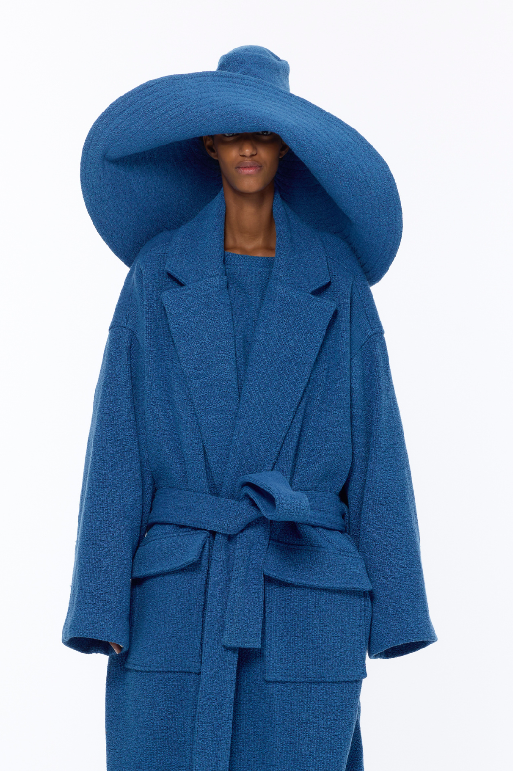 French Blue Bouclé Pamela Hat by Marrakshi Life, crafted in Marrakesh with a wide sculptural brim, soft textured bouclé finish and floral-inspired appliqué detail.