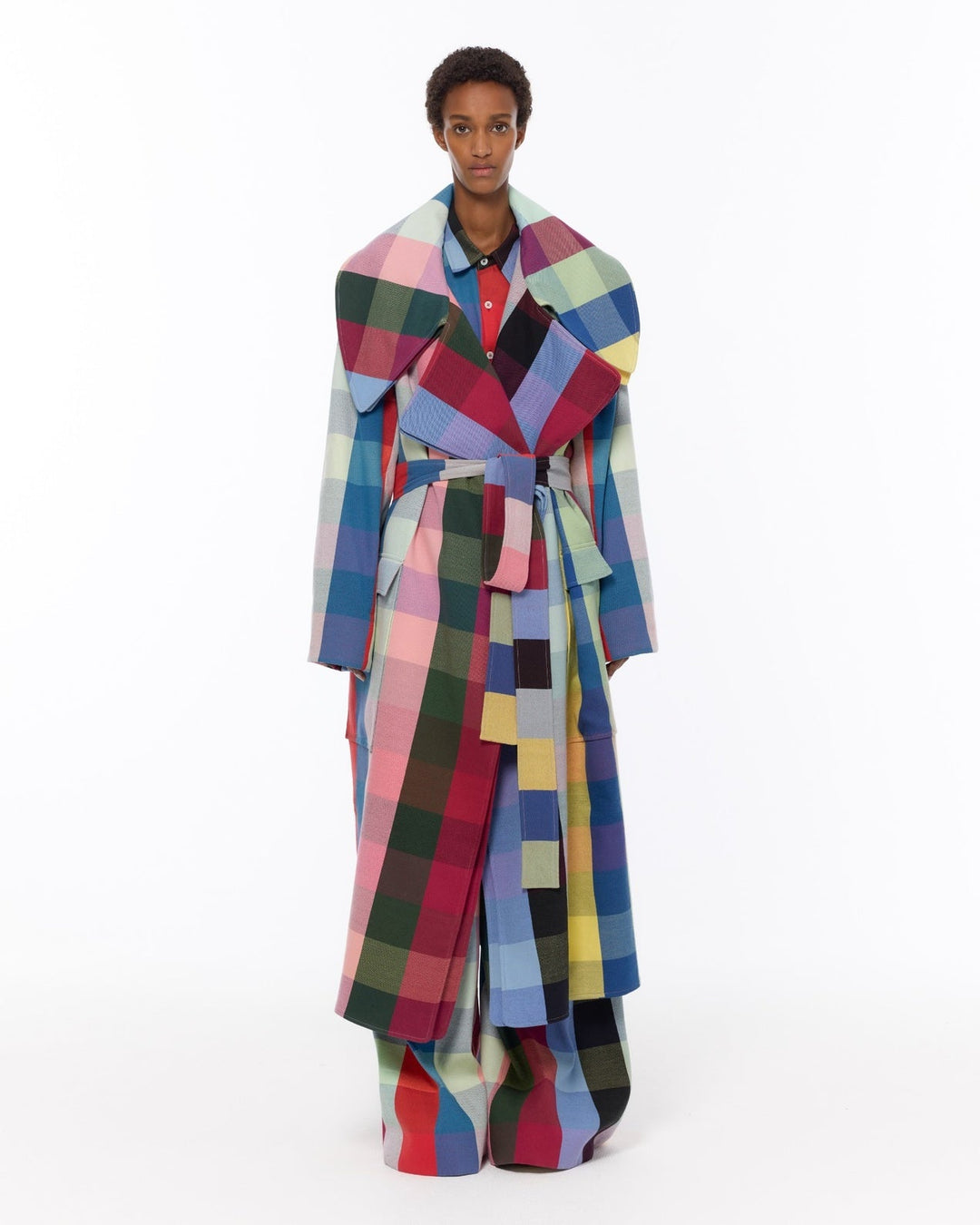 Model is wearing the Double Lapel Overcoat by Marrakshi Life, a hand-woven cotton bouclé coat with oversized plaid, sculptural double lapel and tie belt, curated in the House of Nomad Stories selection.