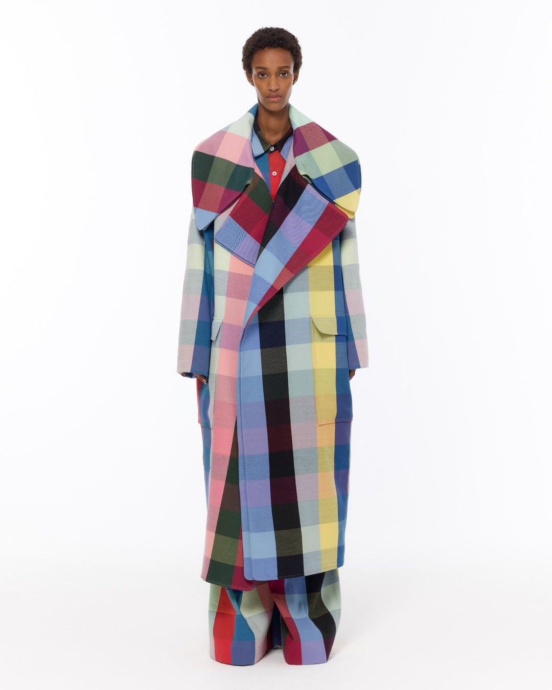 Model is wearing the Double Lapel Overcoat by Marrakshi Life, a hand-woven cotton bouclé coat with oversized plaid, sculptural double lapel and tie belt, curated in the House of Nomad Stories selection.