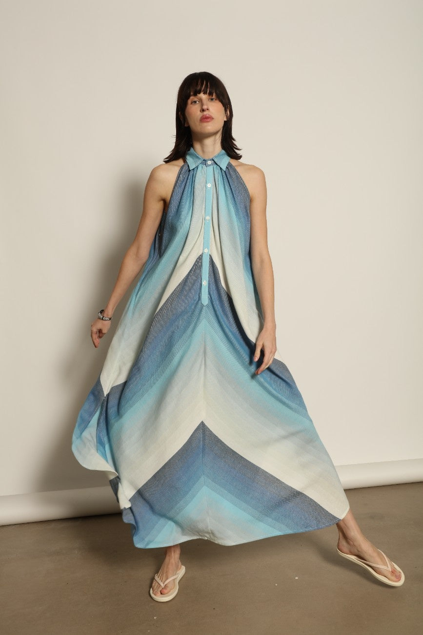 Model is wearing Marrakshi Life halter maxi dress in blue striped cotton, lightweight breathable sleeveless halter neck dress with flowy silhouette from the curated selection of House of Woven Stories
