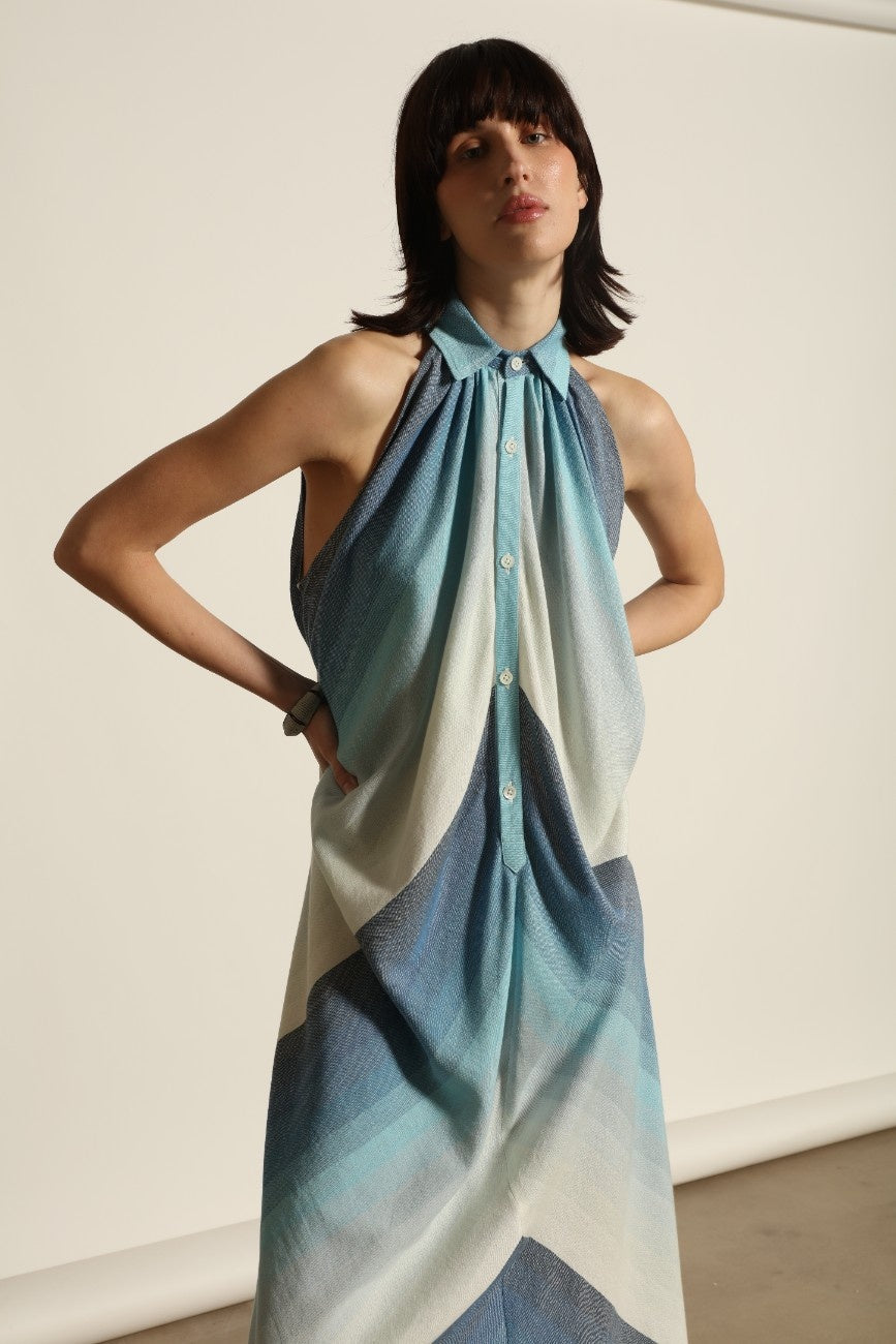 Model is wearing Marrakshi Life halter maxi dress in blue striped cotton, lightweight breathable sleeveless halter neck dress with flowy silhouette from the curated selection of House of Woven Stories