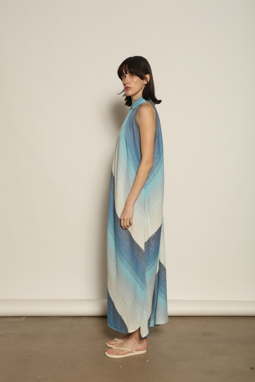 Model is wearing Marrakshi Life halter maxi dress in blue striped cotton, lightweight breathable sleeveless halter neck dress with flowy silhouette from the curated selection of House of Woven Stories