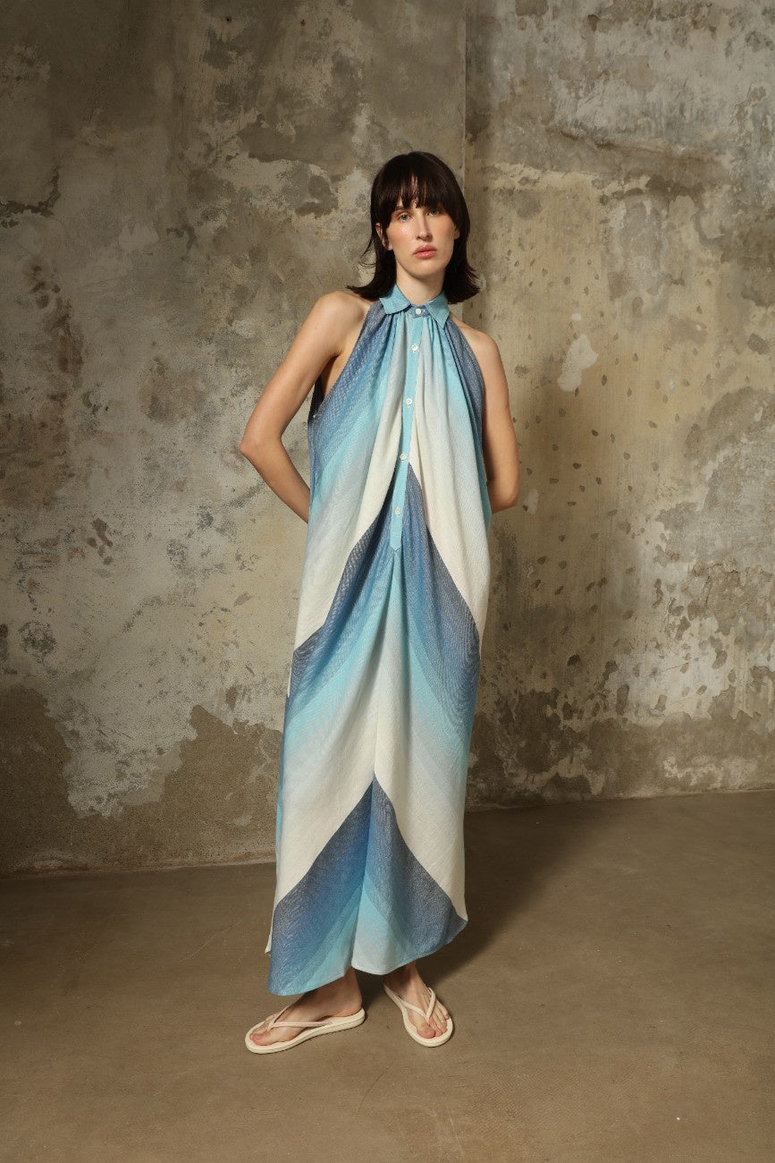 Model is wearing Marrakshi Life halter maxi dress in blue striped cotton, lightweight breathable sleeveless halter neck dress with flowy silhouette from the curated selection of House of Woven Stories
