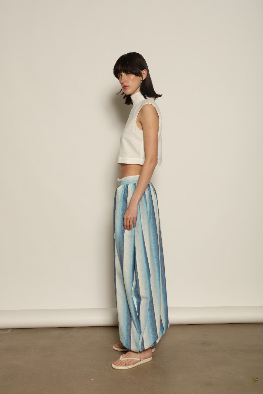 Model is wearing Marrakshi Life harem pants in striped handwoven cotton, voluminous relaxed fit lightweight breathable trousers from the curated selection of House of Woven Stories