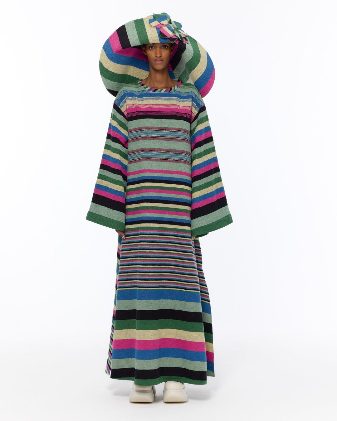 Model is wearing the Kimono Bouclé Multicolor Dress by Marrakshi Life, a hand-woven striped cotton bouclé dress with vibrant colors and flowing kimono sleeves, curated in the House of Nomad Stories selection.
