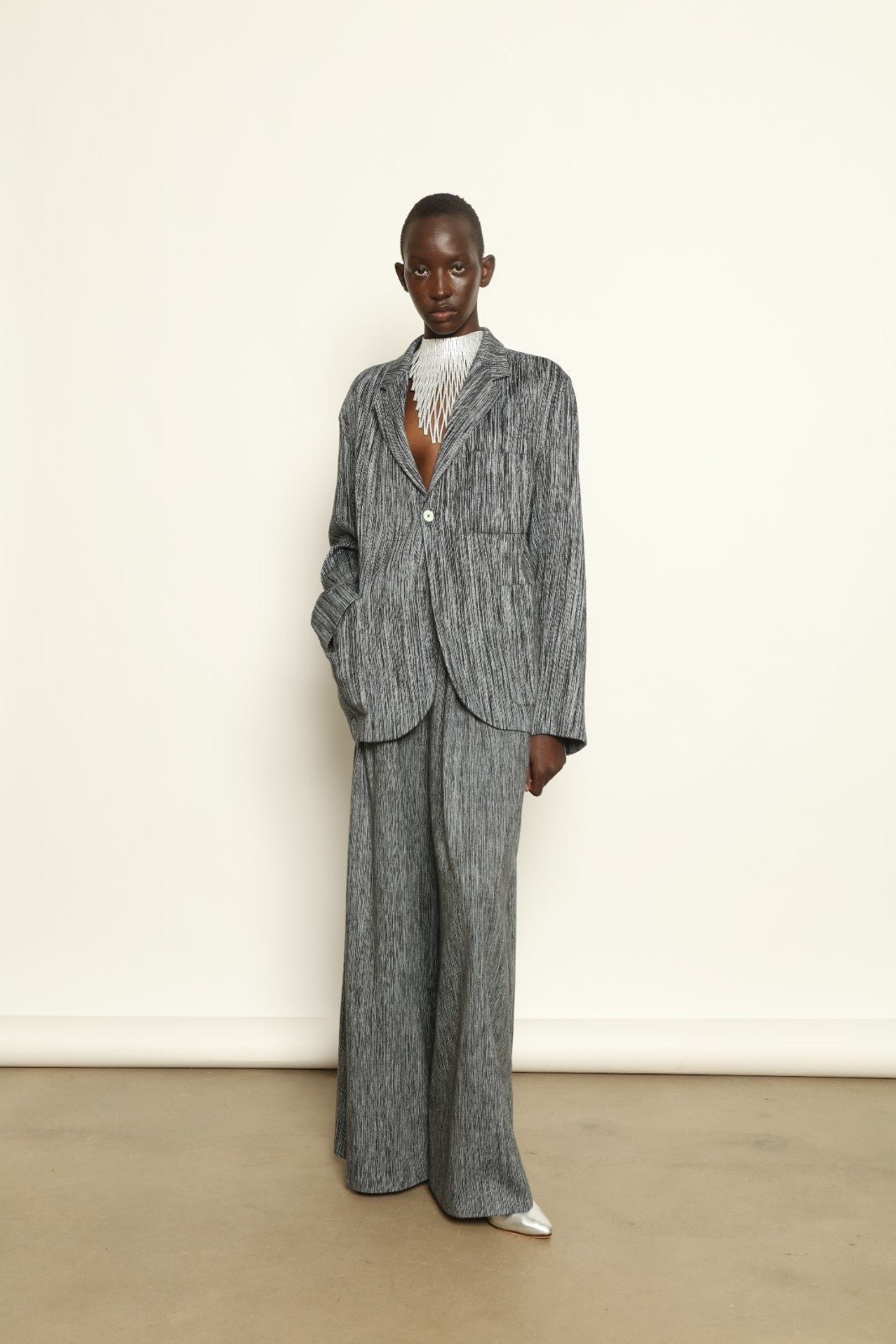 Model is wearing the Mid Rise Grey Chambray Pant by Marrakshi Life, part of House of Nomad Stories collection, handwoven cotton wide-leg pants with relaxed fit and subtle textured chambray