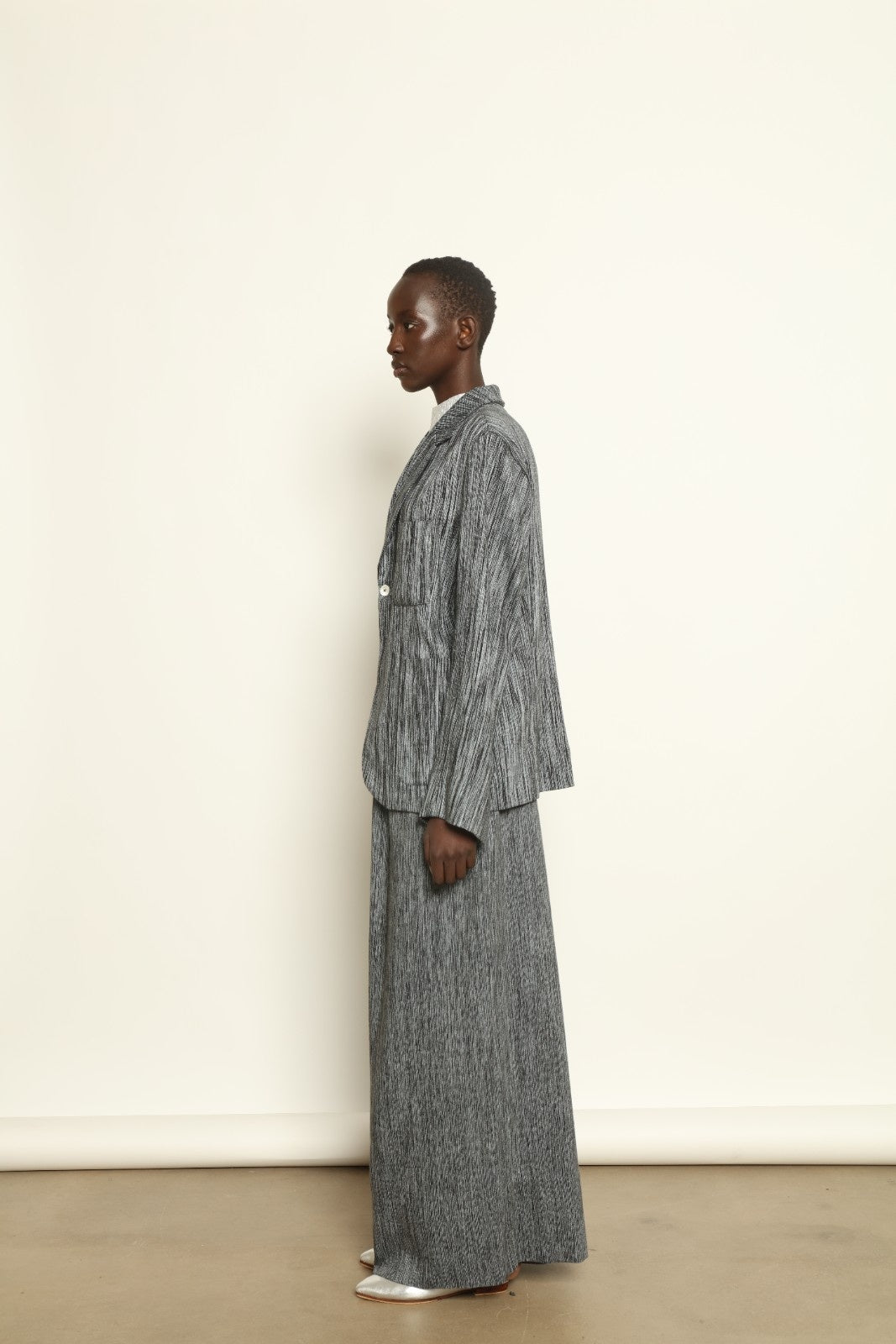 Model is wearing the Mid Rise Grey Chambray Pant by Marrakshi Life, part of House of Nomad Stories collection, handwoven cotton wide-leg pants with relaxed fit and subtle textured chambray