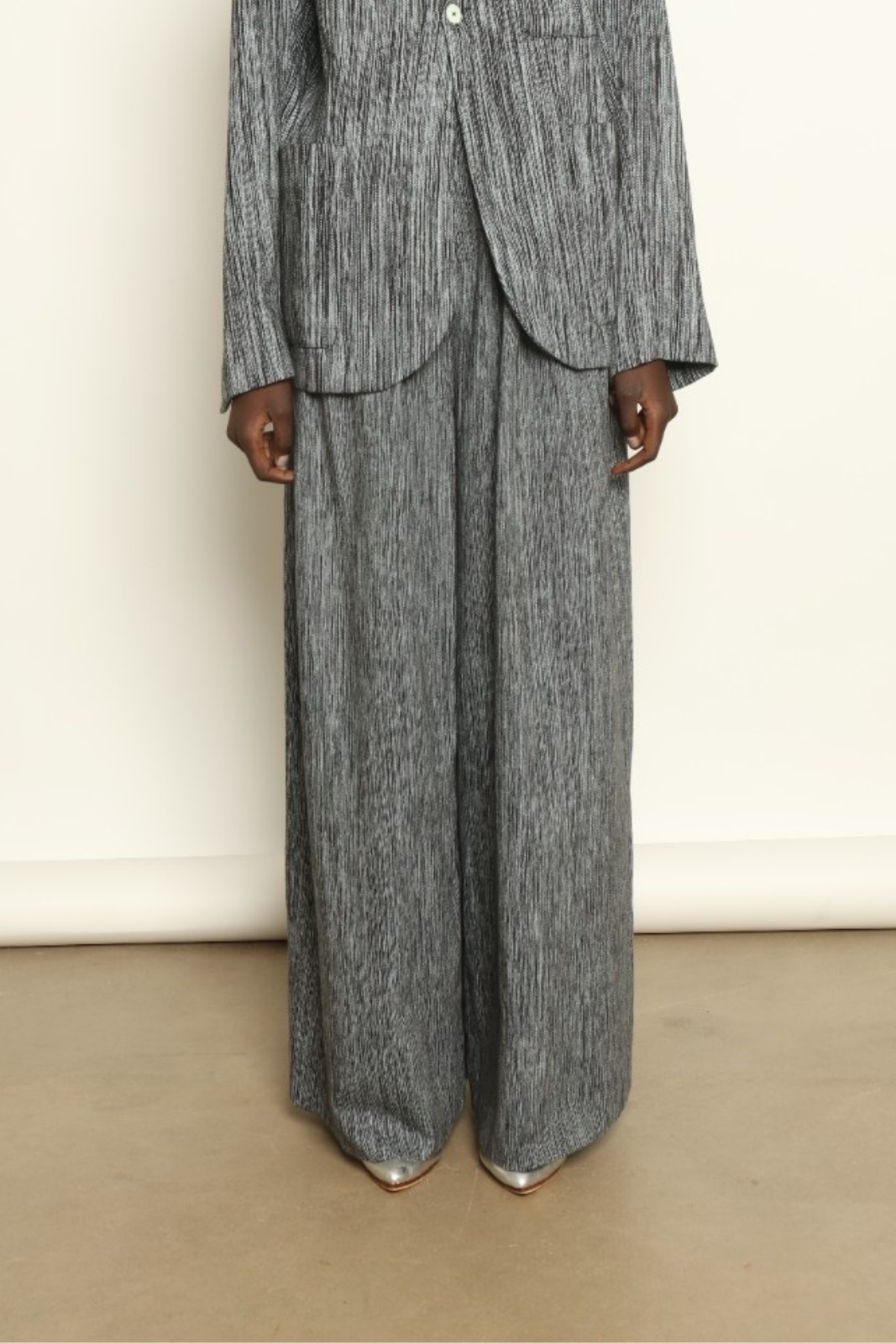 Model is wearing the Mid Rise Grey Chambray Pant by Marrakshi Life, part of House of Nomad Stories collection, handwoven cotton wide-leg pants with relaxed fit and subtle textured chambray