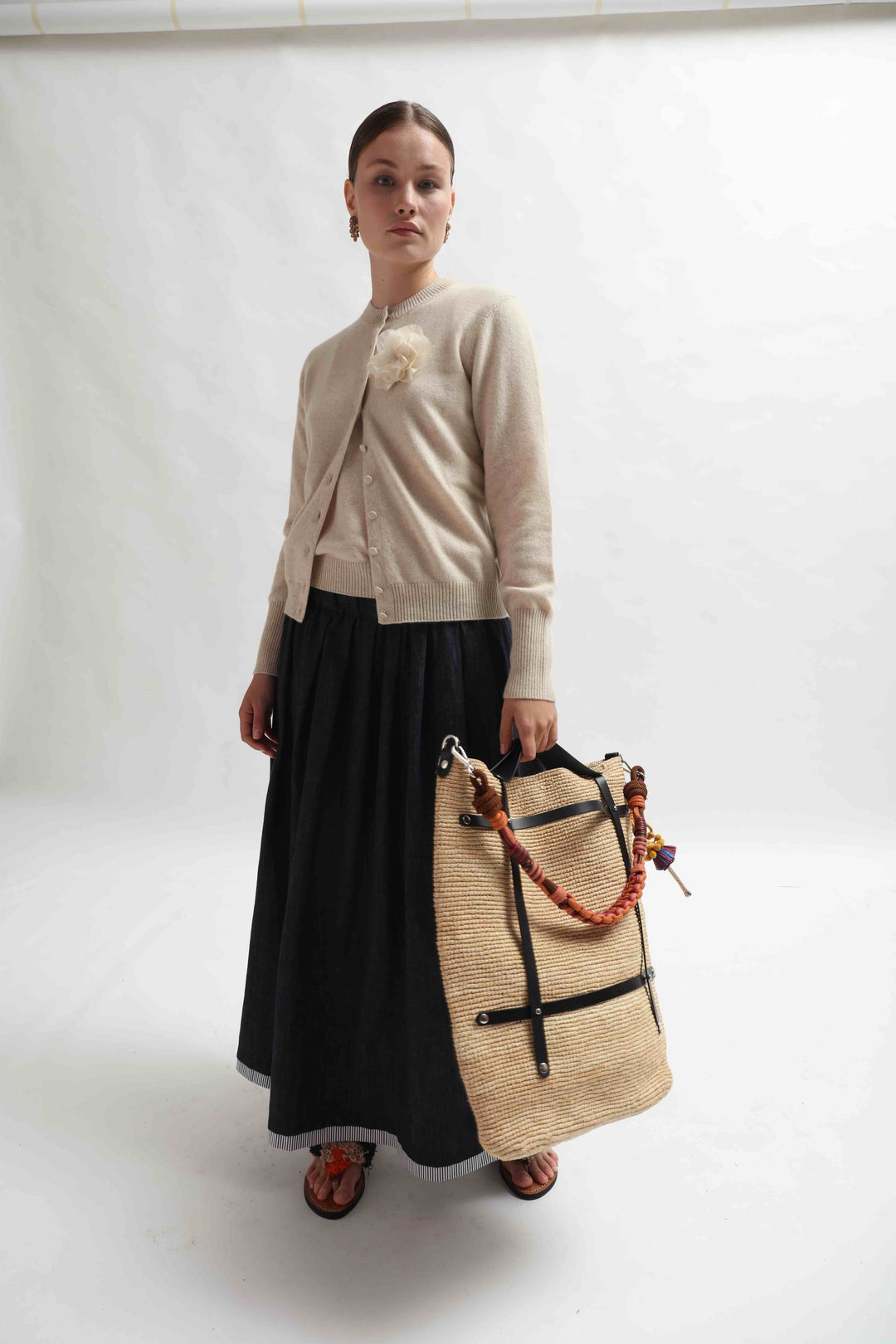 Candide bag made from natural raffia, handcrafted in Belgium. Lightweight and spacious with a casual, refined look. Shown with the colorful Alice Strap by MY BOB (sold separately) for added style and function.