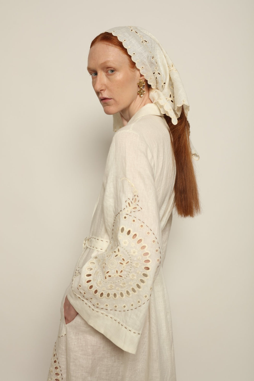 Model is wearing the My Sleeping Gypsy Slavia Head Scarf, handcrafted from linen with intricate embroidery inspired by Slavic heritage, from the House of Nomad Stories selection.