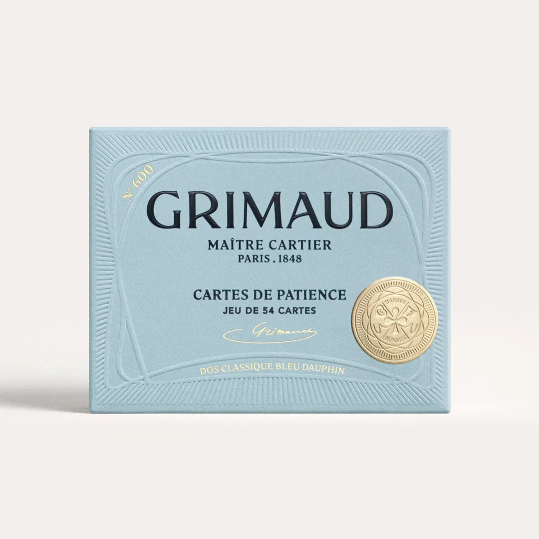 N°600 Cartes de Patience by Grimaud Paris from the House of Woven Stories selection, luxury solitaire playing cards in Dolphin Blue, made in France with gold-gilded corners and illustrated design.