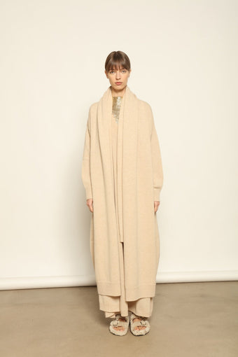 Model wearing the Natural Paula Cashmere Coat by House of Nomad Stories, made from 100% pure Inner Mongolia cashmere, featuring a soft natural shade, open-front design, elegant drape, cozy warmth, and sustainable, ethically crafted luxury