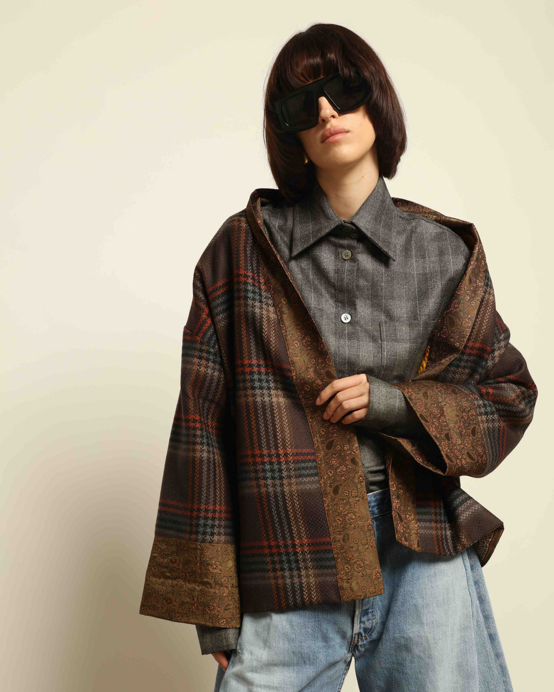 Model is wearing the Obidi Checked Kantha Jacket in wool and silk, with a silk collar and unique printed silk lining, a one-of-a-kind artisanal piece. Part of House of Nomad Stories selection.