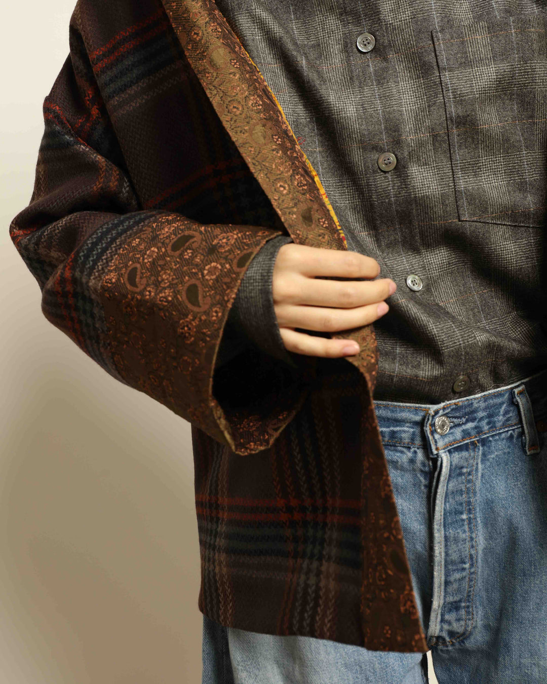 Model is wearing the Obidi Checked Kantha Jacket in wool and silk, with a silk collar and unique printed silk lining, a one-of-a-kind artisanal piece. Part of House of Nomad Stories selection.