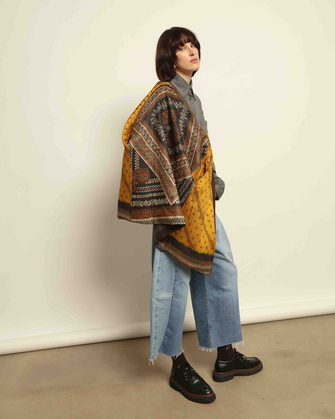 Model is wearing the Obidi Checked Kantha Jacket in wool and silk, with a silk collar and unique printed silk lining, a one-of-a-kind artisanal piece. Part of House of Nomad Stories selection.