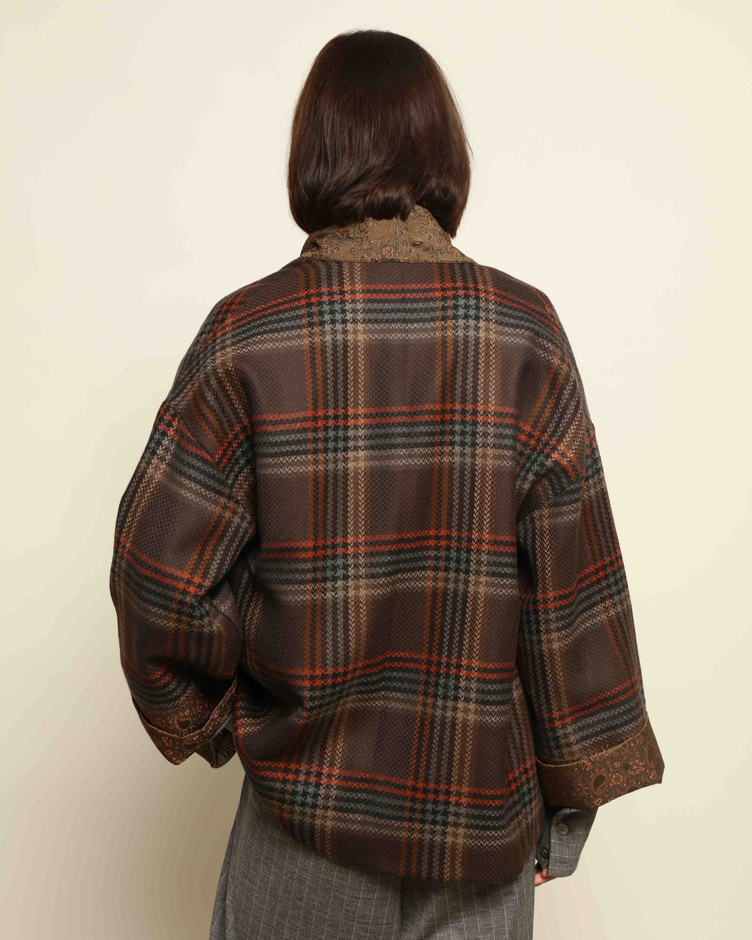 Model is wearing the Obidi Checked Kantha Jacket in wool and silk, with a silk collar and unique printed silk lining, a one-of-a-kind artisanal piece. Part of House of Nomad Stories selection.