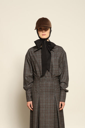 Model is wearing the Oscar Grey Brown Shirt by House of Woven Stories, made from 100% merino wool with a timeless tailored silhouette in grey-brown tones.