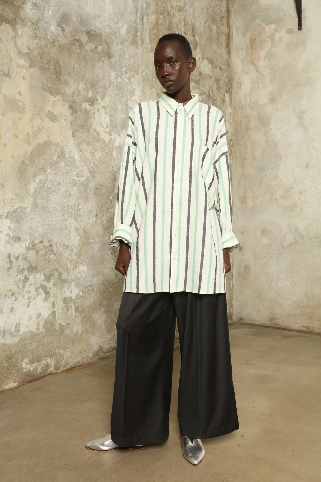 Model is wearing the Oversized Shirt with Collar by Marrakshi Life, part of House of Nomad Stories collection, handwoven cotton shirt with relaxed architectural fit, structured collar, and versatile styling