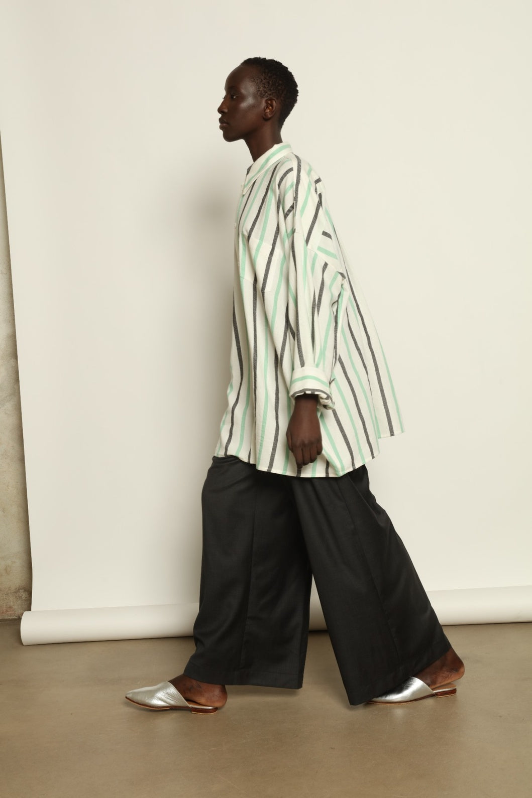 Model is wearing the Oversized Shirt with Collar by Marrakshi Life, part of House of Nomad Stories collection, handwoven cotton shirt with relaxed architectural fit, structured collar, and versatile styling