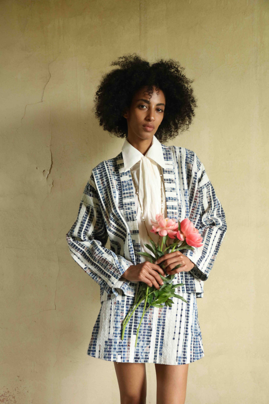 Handwoven from upcycled blue and white fabric waste, this lightweight kimono by Paiwand features a soft, textured finish and celebrates the beauty of conscious craftsmanship and subtle imperfections. Part of House of Woven Stories selection.